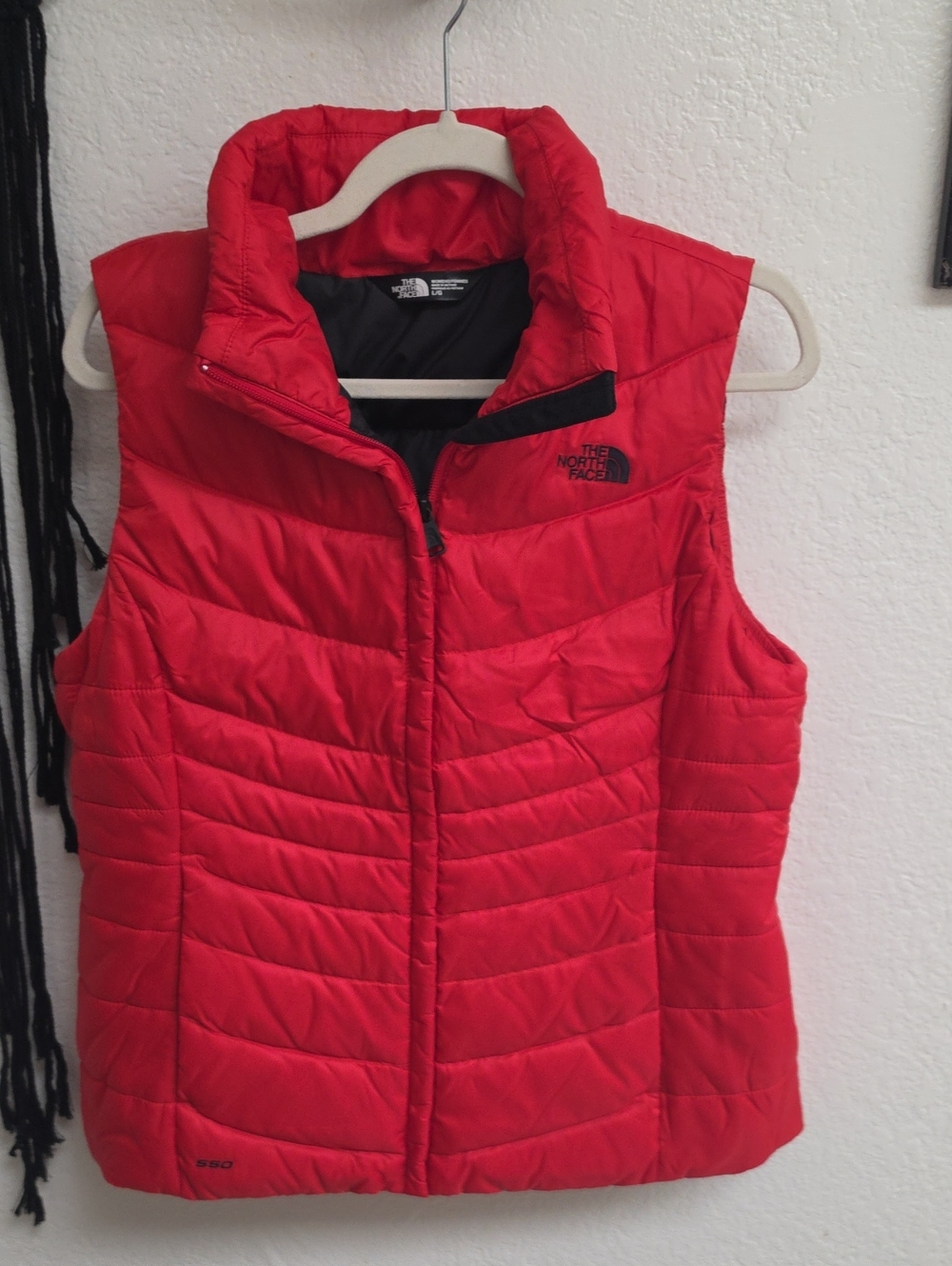 The North Face quilted puffer vest with a high collar and front zipper 550 Fill